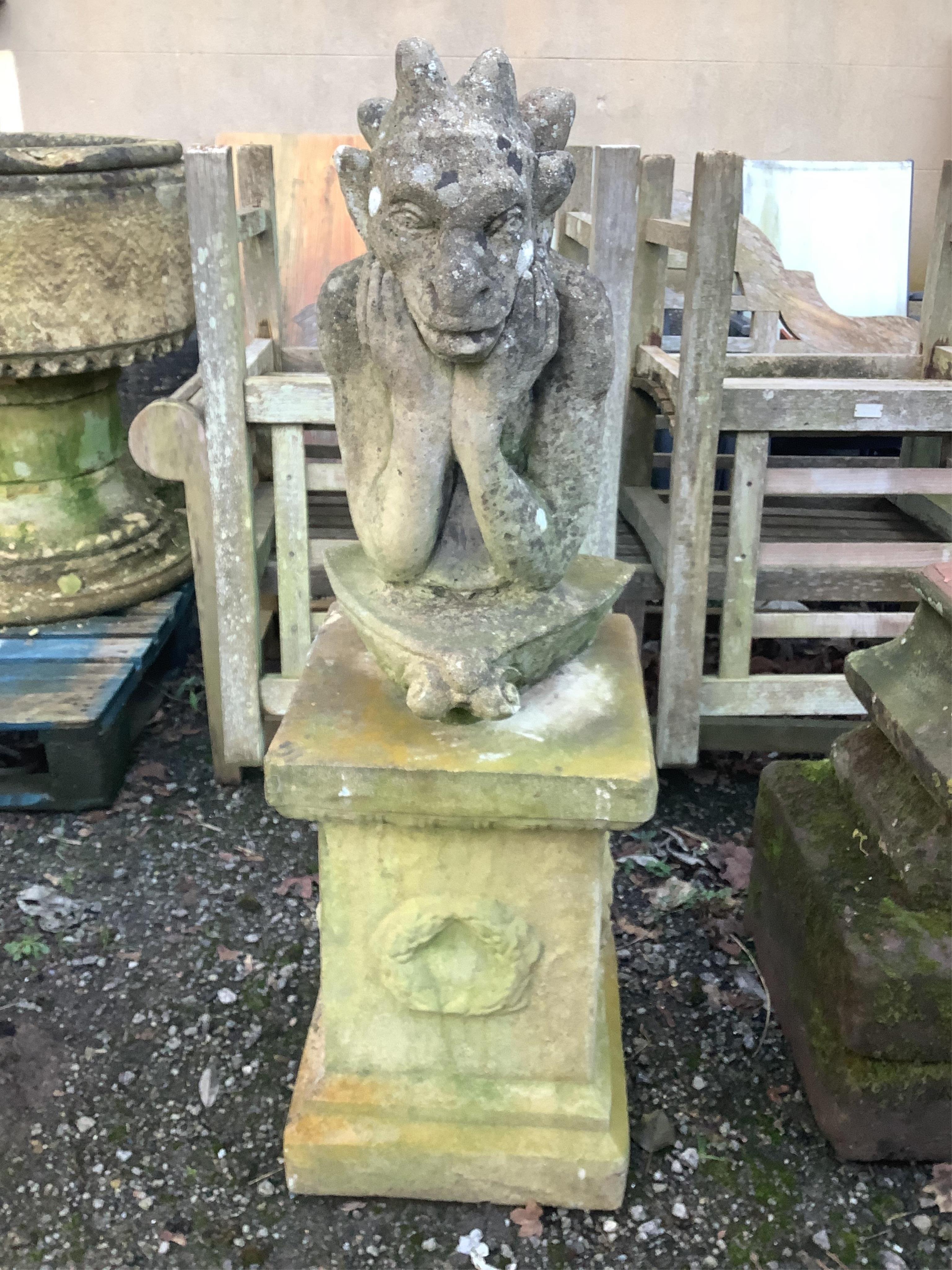 A reconstituted stone gargoyle ornament on square plinth, height 120cm. Condition - fair